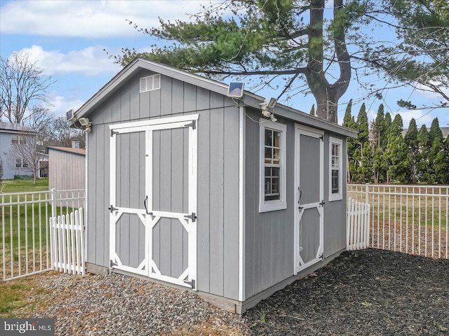 view of shed featuring fence