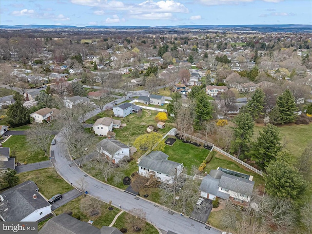 aerial view of property and surrounding area featuring nearby suburban area