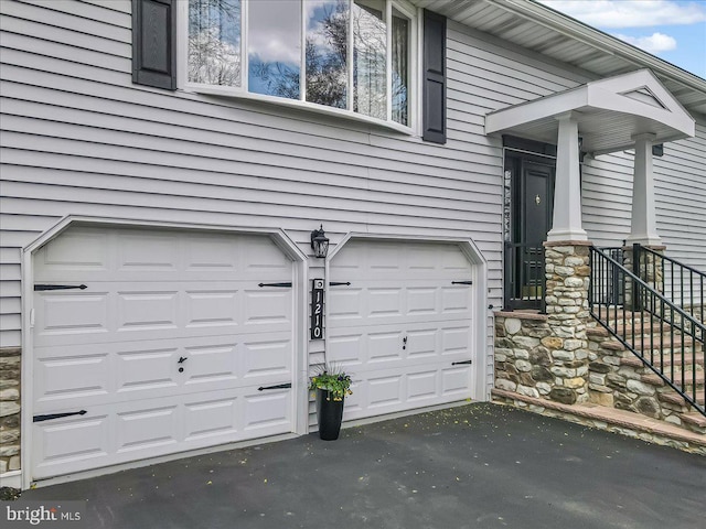 garage with asphalt driveway