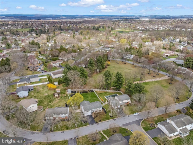 aerial view of property and surrounding area with nearby suburban area