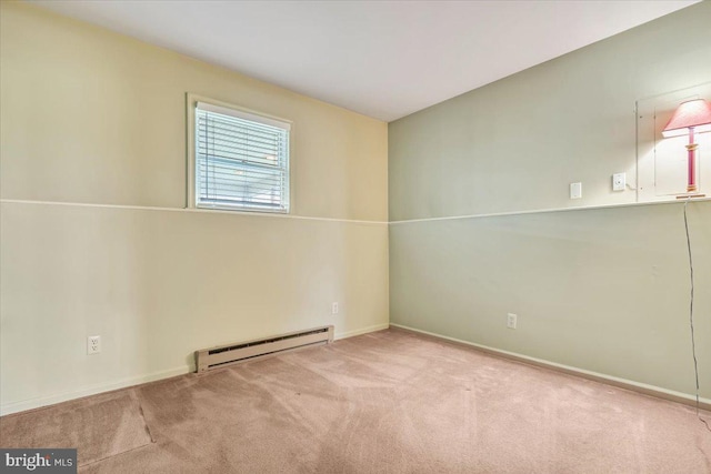 empty room featuring a baseboard radiator, carpet flooring, and baseboards