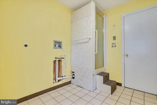 laundry area with electric dryer hookup, hookup for a washing machine, radiator heating unit, and baseboards