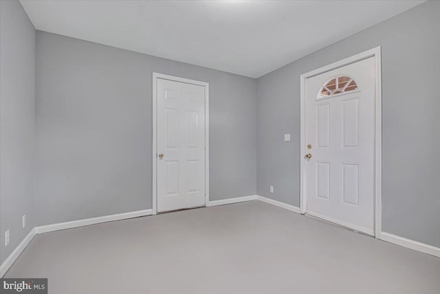 carpeted empty room featuring baseboards