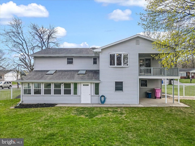 rear view of property with a patio area, roof with shingles, and a balcony