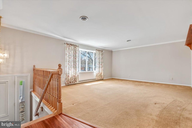 carpeted spare room with crown molding, baseboards, and a chandelier