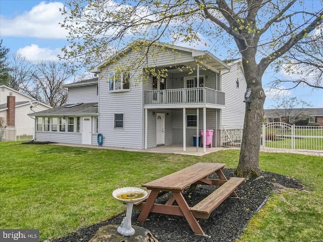 rear view of house with a balcony and a patio area