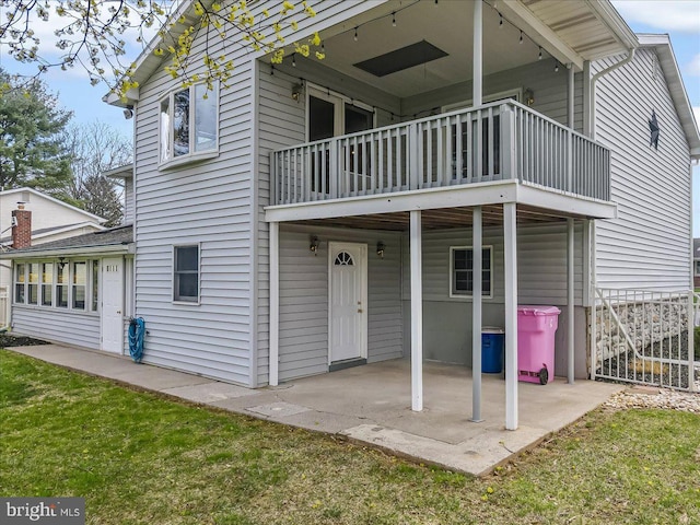 back of house with a balcony and a patio area