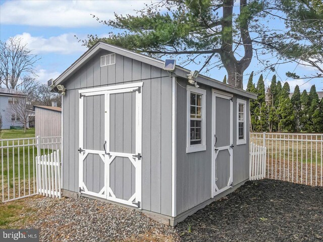 view of shed featuring fence