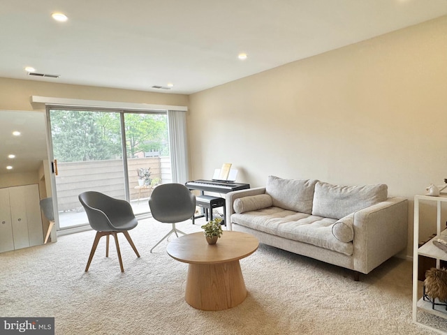 carpeted living area with recessed lighting