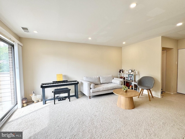 carpeted living area featuring recessed lighting and baseboards
