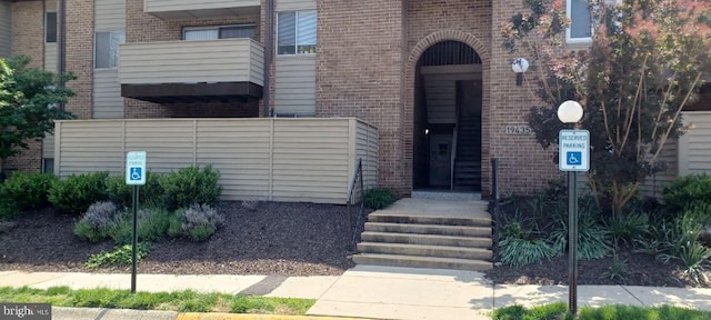 property entrance featuring brick siding