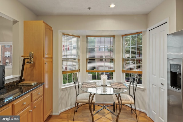 dining room with baseboards, light wood-style flooring, and recessed lighting