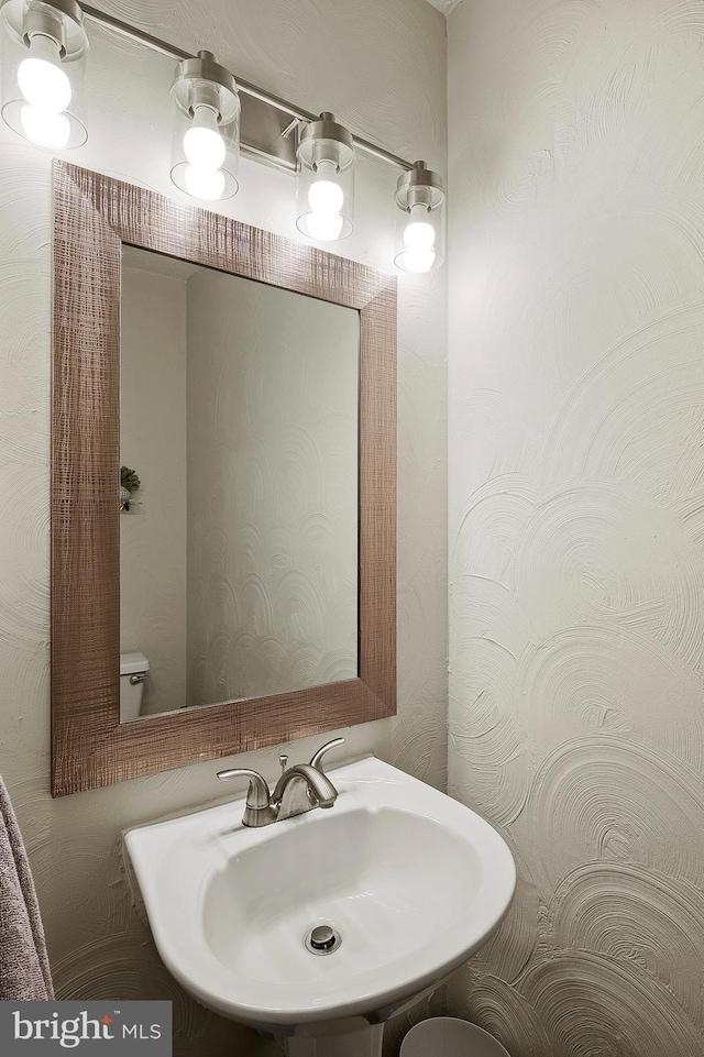 half bath featuring a sink