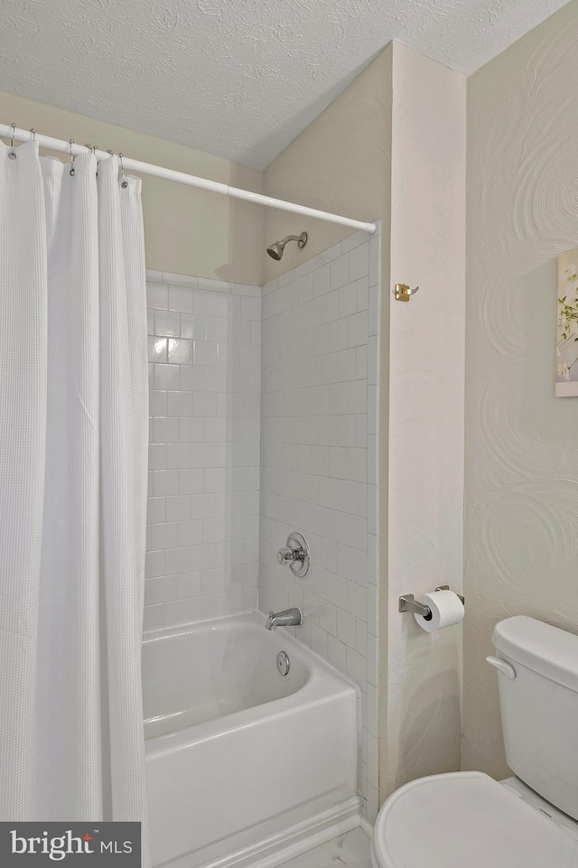 full bathroom featuring toilet, a textured ceiling, and shower / bath combination with curtain