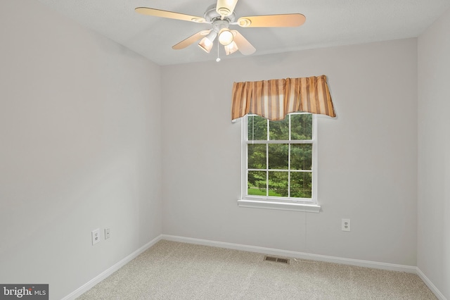 spare room featuring carpet flooring, baseboards, and a ceiling fan