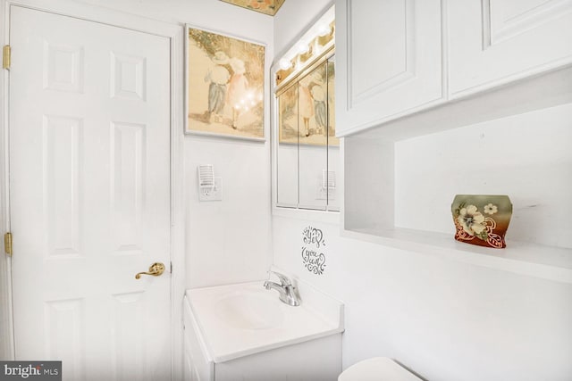 half bathroom featuring toilet and vanity