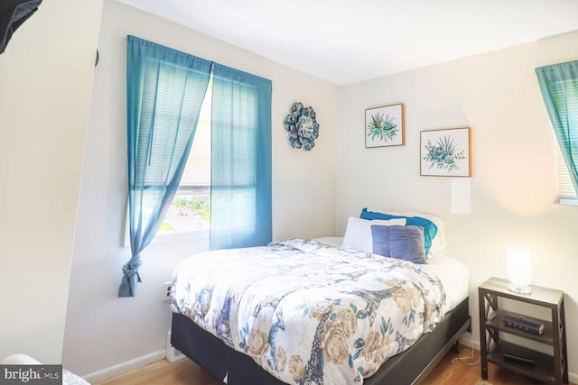 bedroom featuring wood finished floors and baseboards