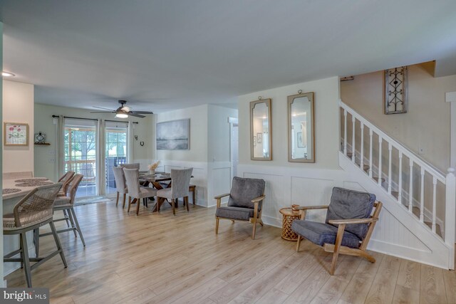 18418 Gravel Hill Rd, Georgetown, DE 19947 - living area featuring stairs, light wood-style floors, wainscoting, and a ceiling fan