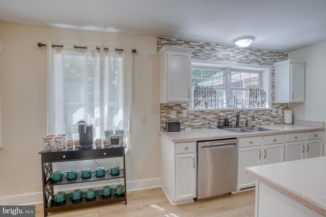 18418 Gravel Hill Rd, Georgetown, DE 19947 - kitchen featuring stainless steel dishwasher, a sink, decorative backsplash, and white cabinetry