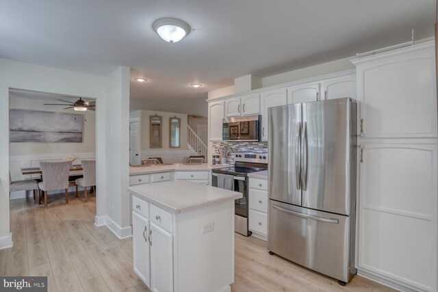18418 Gravel Hill Rd, Georgetown, DE 19947 - kitchen featuring stainless steel appliances, ceiling fan, light countertops, white cabinets, and light wood-type flooring