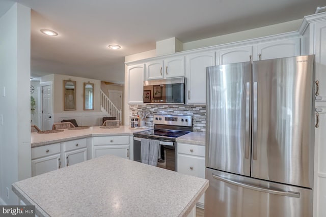 18418 Gravel Hill Rd, Georgetown, DE 19947 - kitchen featuring stainless steel appliances, white cabinetry, light countertops, tasteful backsplash, and recessed lighting
