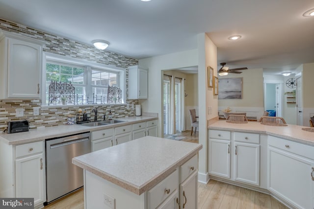 18418 Gravel Hill Rd, Georgetown, DE 19947 - kitchen featuring stainless steel dishwasher, a sink, a ceiling fan, tasteful backsplash, and white cabinetry