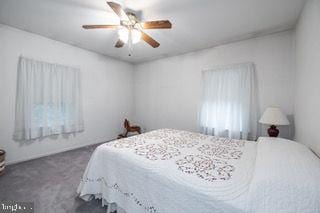 bedroom with dark carpet and ceiling fan