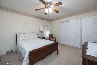 bedroom with light carpet and ceiling fan