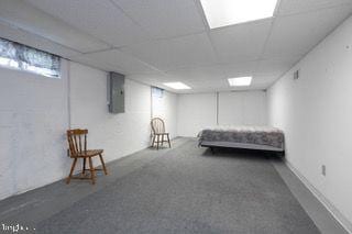 bedroom with electric panel and carpet floors