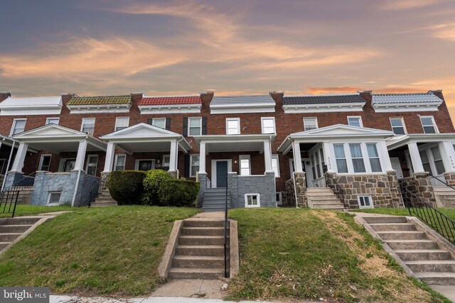 3304 Mondawmin Ave, Baltimore, MD 21216 - multi unit property featuring stairway, stone siding, a tile roof, and a front lawn