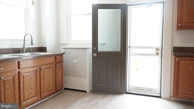 2236 Linden Ave, Baltimore, MD 21217 - kitchen with a sink, plenty of natural light, dark countertops, and light wood finished floors