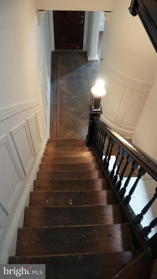 2236 Linden Ave, Baltimore, MD 21217 - stairs featuring a decorative wall, a wainscoted wall, and parquet flooring