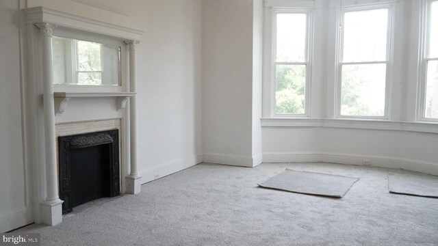 2236 Linden Ave, Baltimore, MD 21217 - unfurnished living room featuring carpet flooring, healthy amount of natural light, a fireplace, and baseboards