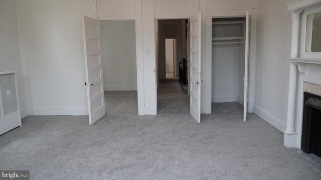 2236 Linden Ave, Baltimore, MD 21217 - unfurnished bedroom with light carpet, a fireplace, a closet, and baseboards