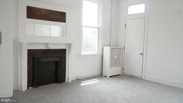 2236 Linden Ave, Baltimore, MD 21217 - unfurnished living room featuring carpet, healthy amount of natural light, and a fireplace
