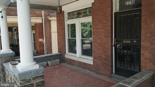 2236 Linden Ave, Baltimore, MD 21217 - view of exterior entry featuring covered porch and brick siding