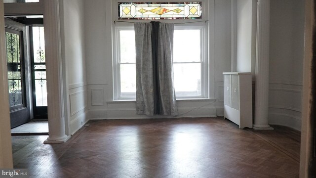2236 Linden Ave, Baltimore, MD 21217 - unfurnished dining area featuring plenty of natural light, ornate columns, and a decorative wall