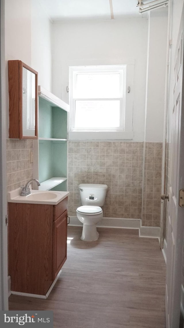 2236 Linden Ave, Baltimore, MD 21217 - bathroom with wood finished floors, toilet, vanity, and tile walls