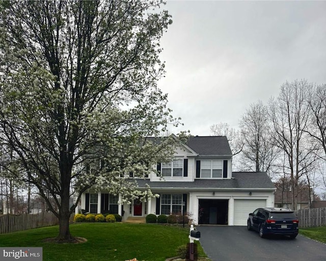 traditional-style home with asphalt driveway and an attached garage