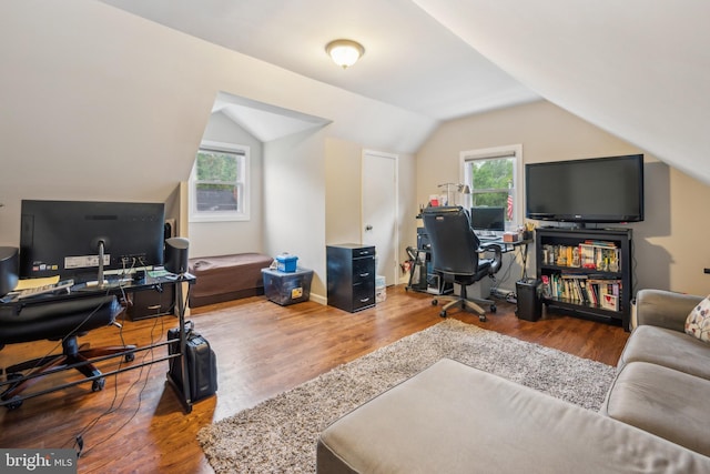 office area with wood finished floors and vaulted ceiling