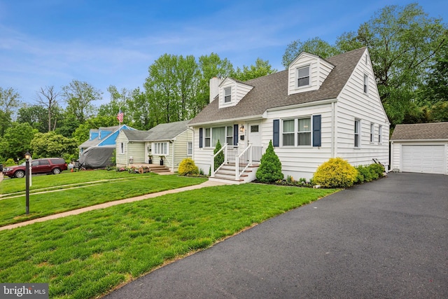 cape cod house with an outdoor structure, a shingled roof, a front lawn, a garage, and driveway