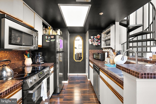 1019 Summerglenn Ct Unit 7-302, Bowie, MD 20721 - kitchen with appliances with stainless steel finishes, dark wood-type flooring, backsplash, white cabinets, and wooden counters