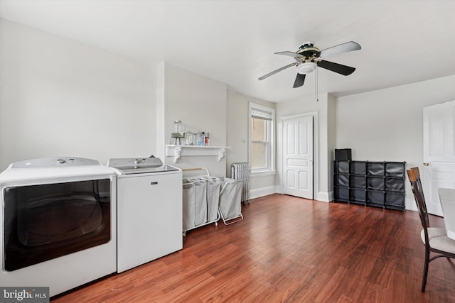 washroom with washing machine and dryer, wood finished floors, ceiling fan, and baseboards
