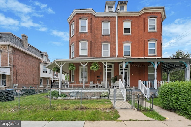 view of front facade featuring a porch, a fenced front yard, brick siding, and a gate