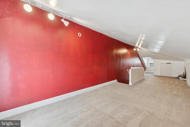 bonus room with lofted ceiling, carpet, and baseboards