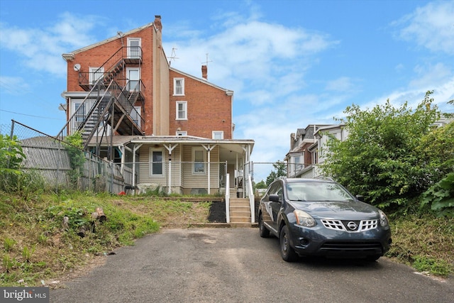 view of front of home with stairway and covered porch