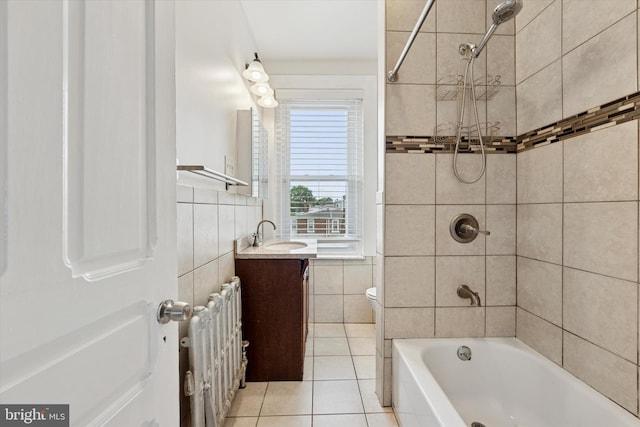 full bathroom with radiator heating unit, tile patterned flooring, vanity, tile walls, and shower / bathtub combination
