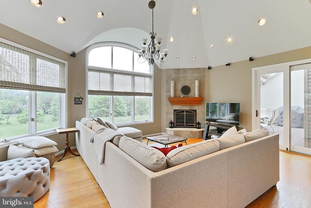 4501 Highland Green Ct, Alexandria, VA 22312 - living room with a chandelier, recessed lighting, light wood finished floors, a tiled fireplace, and baseboards