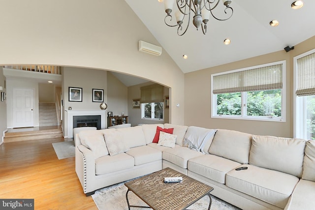 4501 Highland Green Ct, Alexandria, VA 22312 - living room featuring an AC wall unit, light wood finished floors, healthy amount of natural light, recessed lighting, and high vaulted ceiling