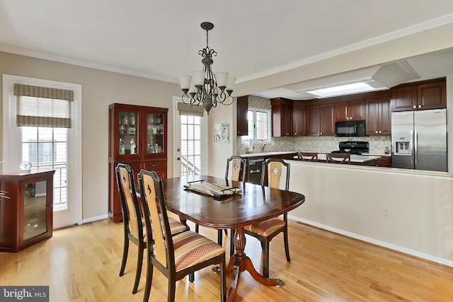 4501 Highland Green Ct, Alexandria, VA 22312 - dining room with light wood finished floors, a chandelier, ornamental molding, and baseboards